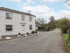 A cottage near the road at Smithy Cottage at Bowland Bridge in Bowness