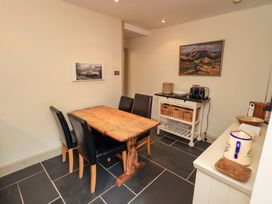 A kitchen with a wooden table and four black chairs at Beck Steps in Chapel Stile