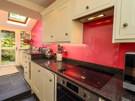 A kitchen with cabinets and a sink at Beck Steps in Chapel Stile