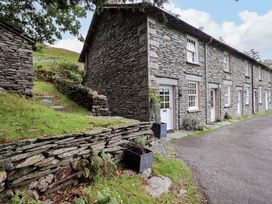 An outdoor view of a stone building with a path and planter at Beck Steps in Chapel Stile