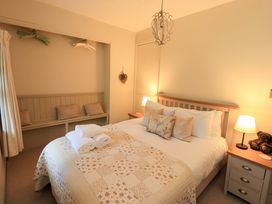 A bedroom with a bed and bedside table at Beck Steps in Chapel Stile