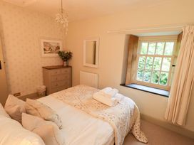 A bedroom with a double bed and window at Beck Steps in Chapel Stile