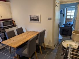 A kitchen with a wooden table and chairs at Beck Steps in Chapel Stile