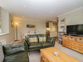 A living room with a sofa and television at Middlerigg in Troutbeck