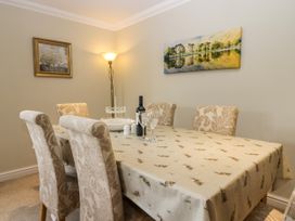 A dining room with a table and chairs at Middlerigg in Troutbeck