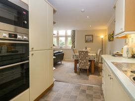 A kitchen area with appliances and a dining table at Middlerigg in Troutbeck