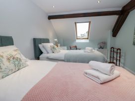 A bedroom with two beds and a window at Middlerigg in Troutbeck