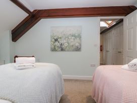 A bedroom with two beds and a painting at Middlerigg in Troutbeck