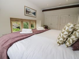 A bedroom with a bed and pillows at Middlerigg in Troutbeck
