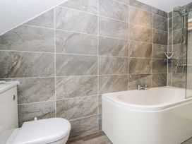 A bathroom with a bathtub and toilet at Middlerigg in Troutbeck