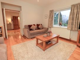A living room with a sofa and coffee table at Fairfield Cottage in Grasmere