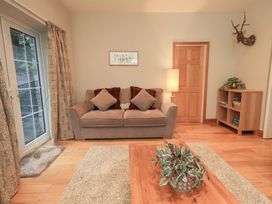 A living room with a sofa and a table at Fairfield Cottage in Grasmere