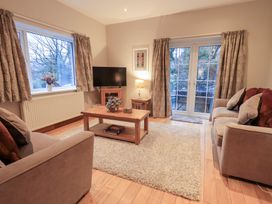 A living room with a sofa and television at Fairfield Cottage in Grasmere