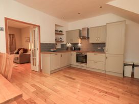 A kitchen with cabinetry and appliances at Fairfield Cottage in Grasmere