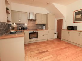 A kitchen with cabinets and appliances at Fairfield Cottage in Grasmere