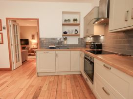 A kitchen with cabinets and a sink at Fairfield Cottage in Grasmere