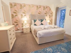 A bedroom with a bed and bedside table at Fairfield Cottage in Grasmere