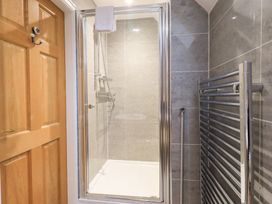 A bathroom with a shower and heated towel rail at Fairfield Cottage in Grasmere