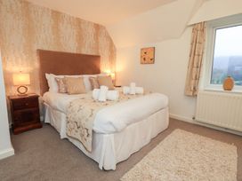 A bedroom with a bed and nightstand at Fairfield Cottage in Grasmere