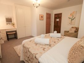 A bedroom with a bed, desk, and chair at Fairfield Cottage Grasmere