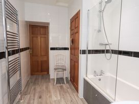 A bathroom with a bathtub and shower at Fairfield Cottage in Grasmere