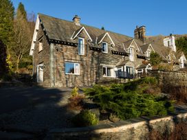 A house with stone exterior and windows at Fairfield Cottage in Grasmere