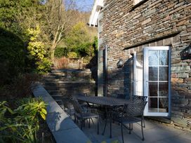 An outdoor patio with a table and chairs at Fairfield Cottage in Grasmere