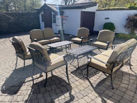 A seating area with chairs and tables at Bank Barn at Rusland in Grizedale