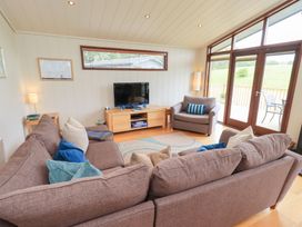 A living room with a television and sofa at Thie Loghey in Hawkshead