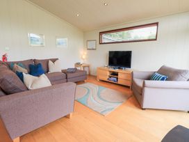 A living room with a sofa and television at Thie Loghey in Hawkshead