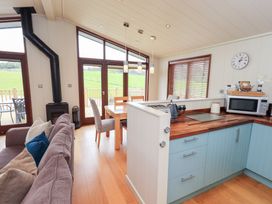 A kitchen with dining table and chairs at The Loghey in Hawkshead