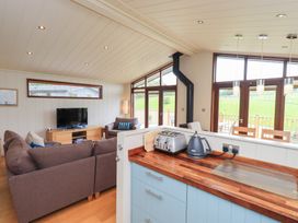 A living room with a television and sofa at Thie Loghey in Hawkshead