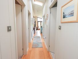 A hallway with doors and a rug at Thie Loghey in Hawkshead