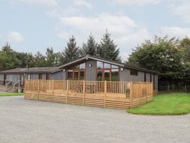 A house with a wooden deck and windows at Thie Loghey in Hawkshead