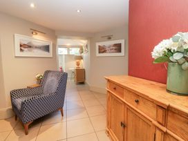 A hallway with a chair and sideboard at Archie's in Ambleside