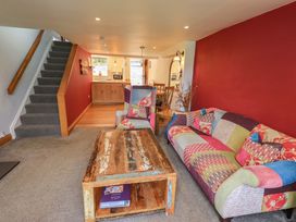 A living room with a sofa and coffee table at Boxwood Cottage in Troutbeck