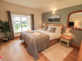 A bedroom with a bed and window at Boxwood Cottage in Troutbeck