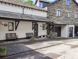 An outdoor area with benches and a stone wall at Ghyll Heights in Ambleside