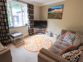 A living room with a couch and television at Ghyll Heights in Ambleside