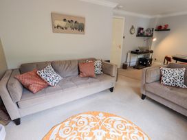 A living room with two sofas and a rug at Ghyll Heights in Ambleside