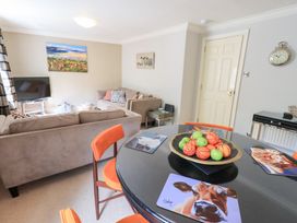 A living room with a sofa and television at Ghyll Heights in Ambleside