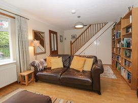 A living room with a sofa and bookshelf at Redwood in Ambleside