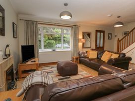 A living room with a television and sofa at Redwood in Ambleside