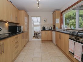A kitchen with appliances and cabinets at Redwood in Ambleside