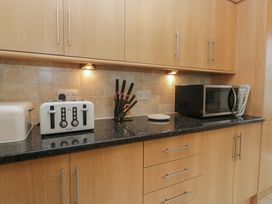 A kitchen with appliances including a toaster and microwave at Redwood in Ambleside