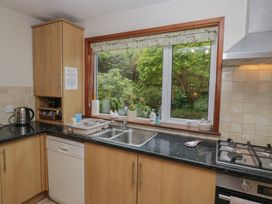 A kitchen with cabinets and sink at Redwood in Ambleside