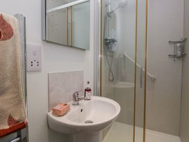 A bathroom with a sink and shower at Redwood in Ambleside