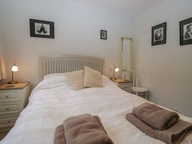 A bedroom with a bed and bedside table at Redwood in Ambleside