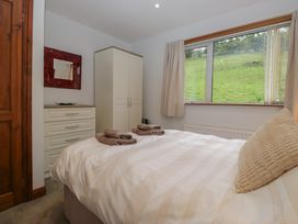 A bedroom with a bed and dresser at Redwood in Ambleside
