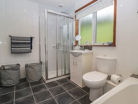 A bathroom with a shower, sink, and toilet at Redwood in Ambleside
